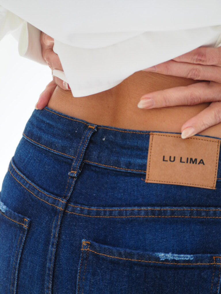 Calça feminina jeans azul com barra dobrada, cintura alta e corte skinny ajustado; tecido algodão com elastano